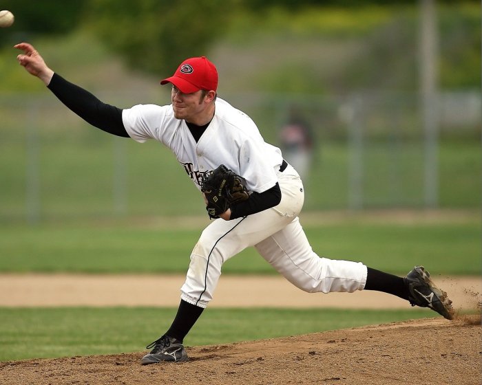 A baseball pitcher throws the ball in a motion